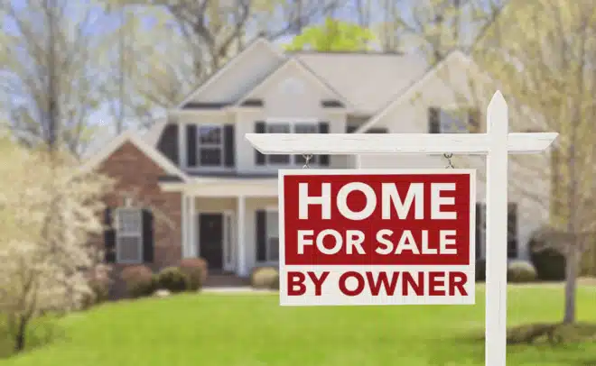 Long Island home with "For Sale By Owner" sign in the front yard.